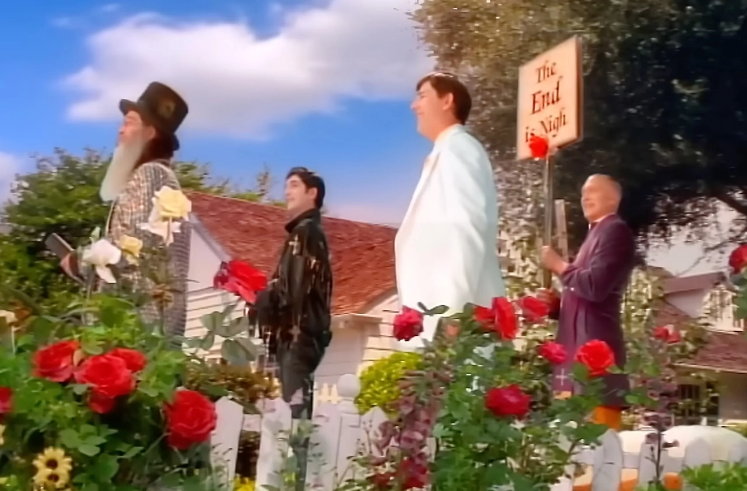 In a colorful garden, 4 men dressed in strange outfits.